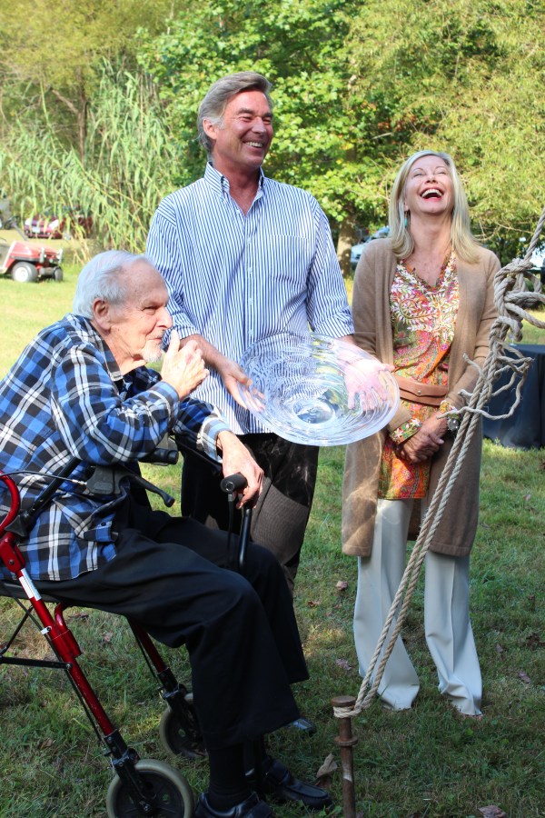 Jim Duke receives the award from John Easterling and Olivia Newton John